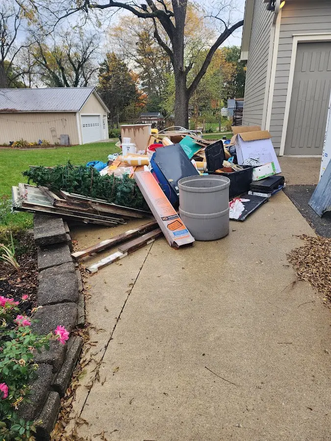 Dumpster being loaded with debris for Estate Cleanout Dumpster Rental in Trafford